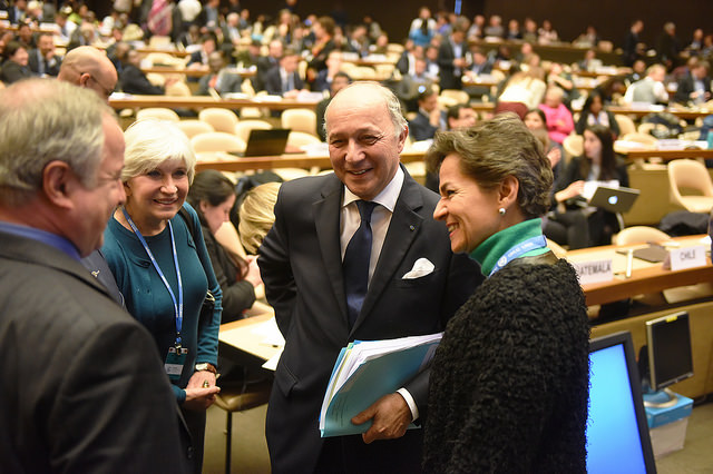 Two women and two men gather in a circle to talk during a UN meeting.