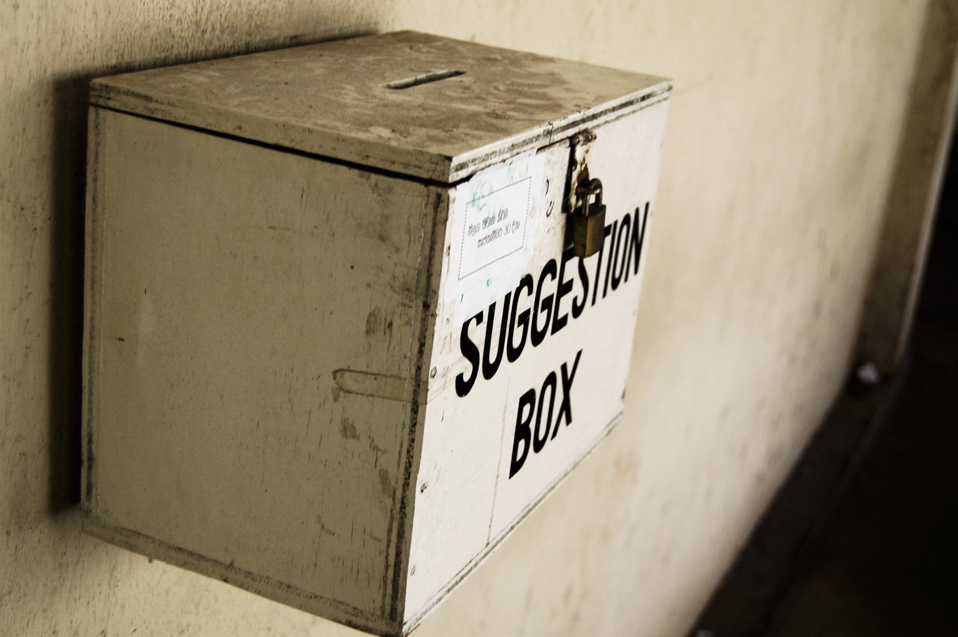 Old box for submitting complaints nailed to a wall.