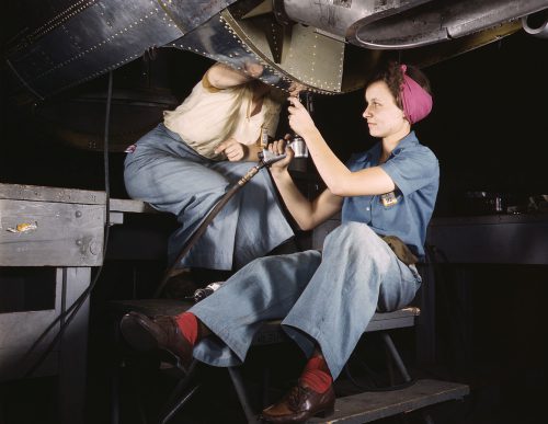 Two women workers work on a aircraft