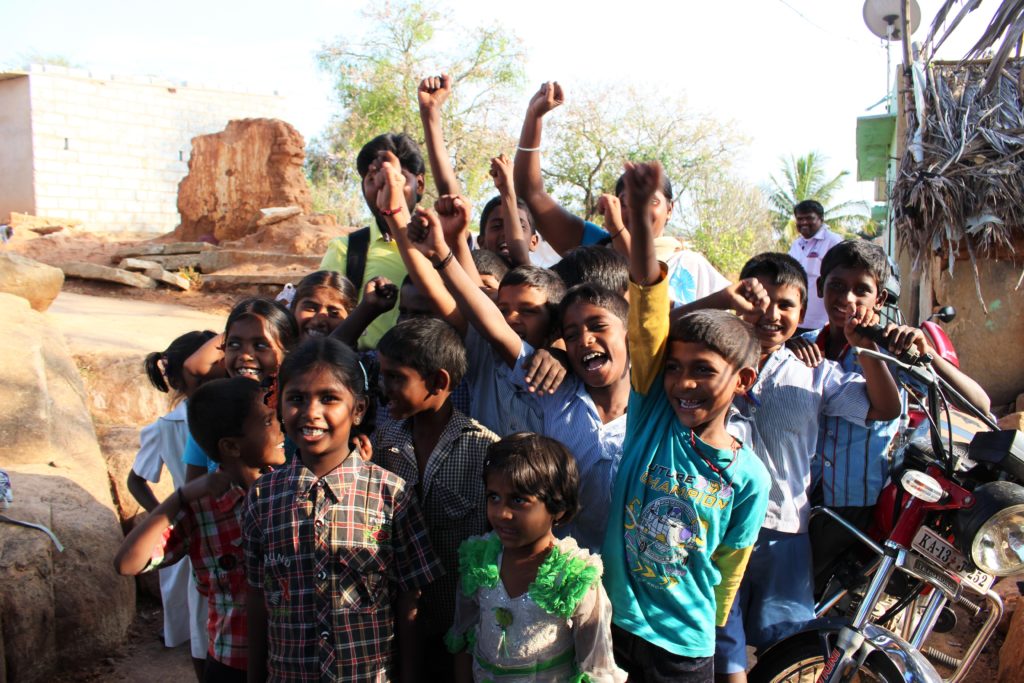 Happy children raising their fists