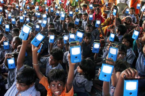 Young children raise their blue digital devices toward the sky.
