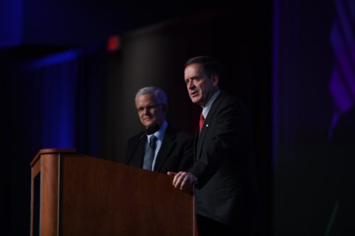 sam worthington and usaid administrator at a podium