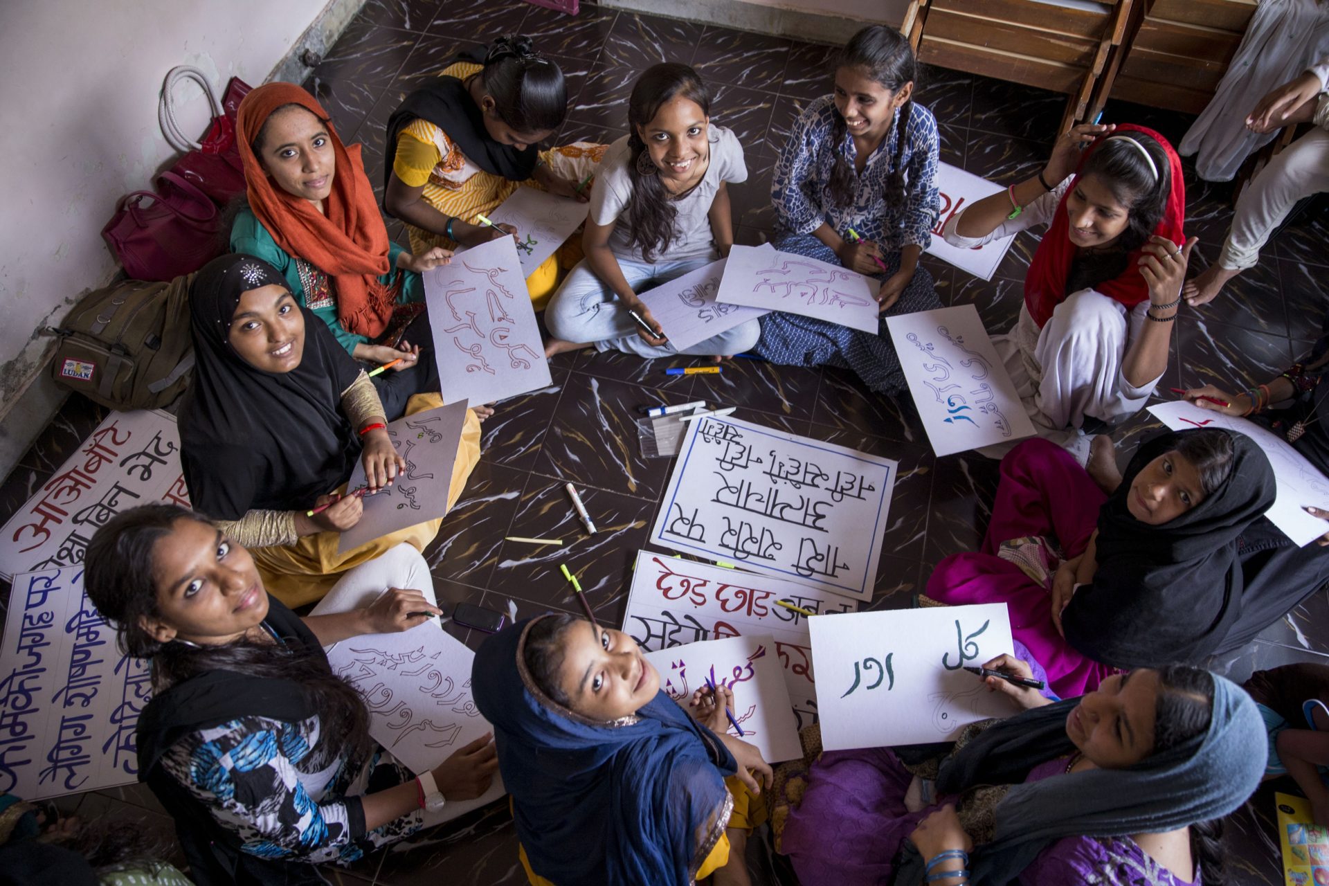 girls sitting around a circle reading and writing