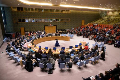 A view of the U.N. Security Council members signaling their abstention. They sit in an open circle in the U.N.'s New York office.